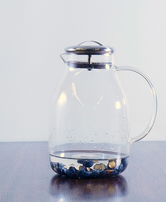 clear pitcher with water and blueberries
